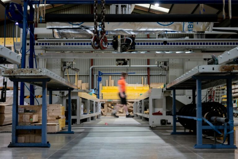 Leader walking through an industrial factory while assessing business performance