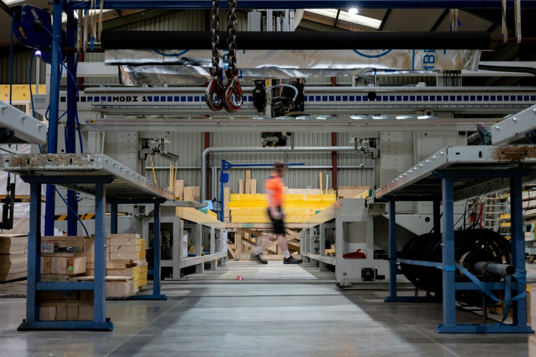 Leader walking through an industrial factory while assessing business performance