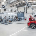 Automotive technicians working in a bright workshop