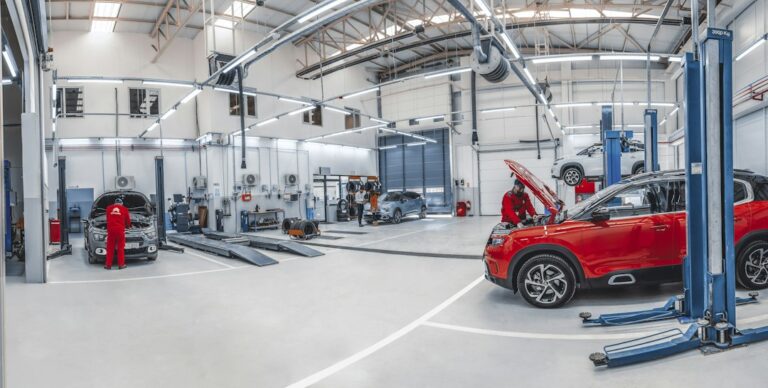Automotive technicians working in a bright workshop