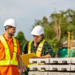 Supervisor and engineer reviewing work together on a factory floor